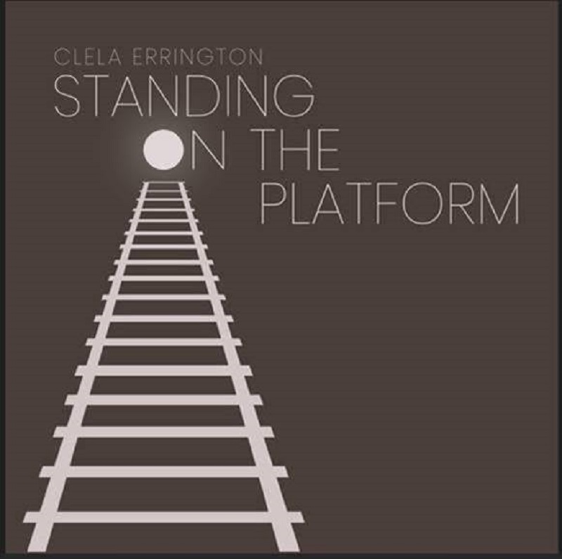 CLELA ERRINGTON STANDING ON THE PLATFORM